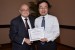 Dr. Nagib Callaos, General Chair, giving Dr. Hideki Yamamoto the best paper award certificate of the session "Bio- and Medical Informatics and Cybernetics II." The title of the awarded paper is "Measurement of Viscosity Change for Horse Artery Blood with Treadmill Exercise Using Falling Needle Rheometer."